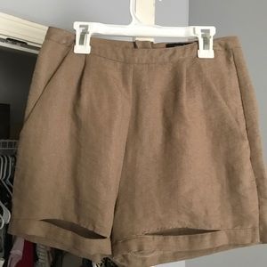 Tan shorts. The holes are meant to be there!